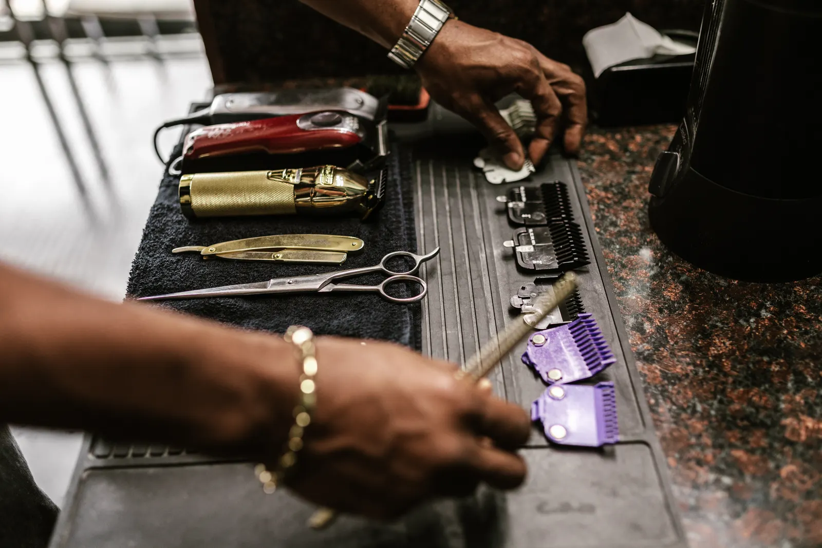 Barber clippers, combs and grooming tools arranged on a work surface